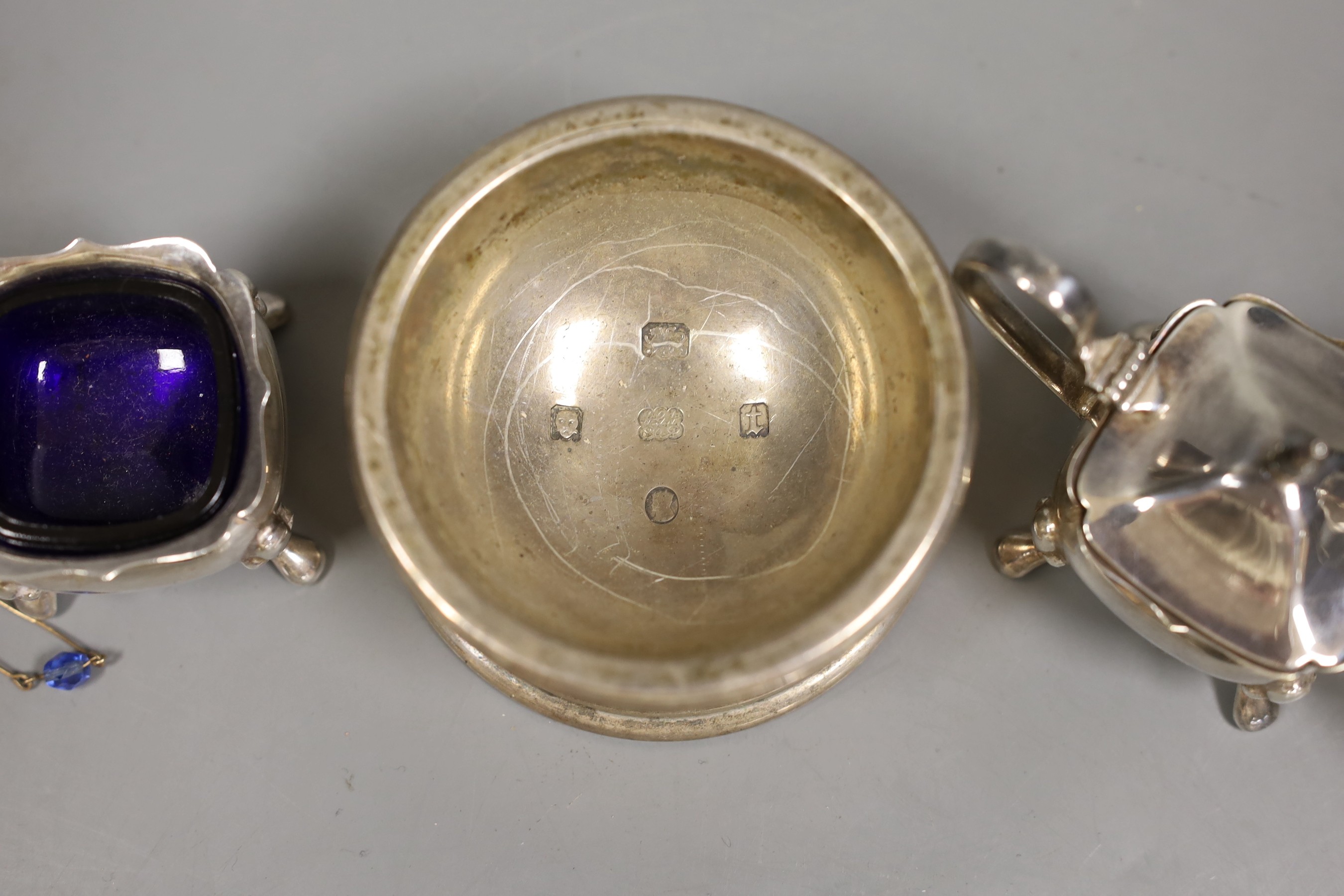 A George V silver jubilee commemorative trencher salt, London 1935, 5oz, and a three piece plated condiment set